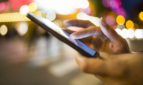 Close up of hands operating a smartphone