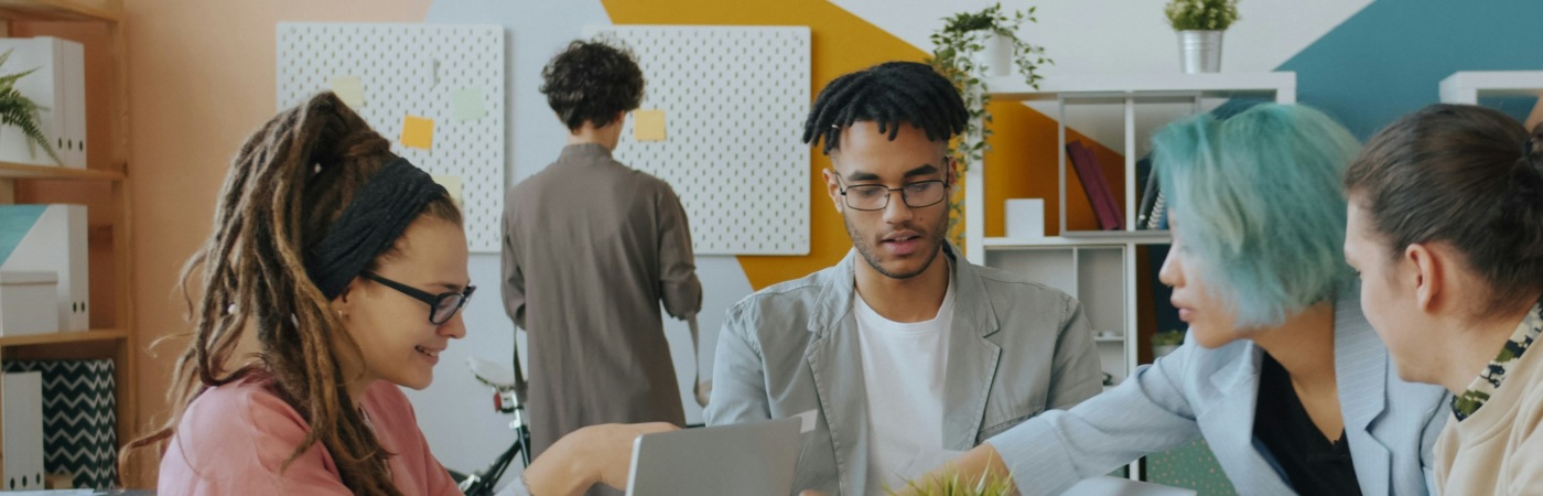 A group of people working around a table.