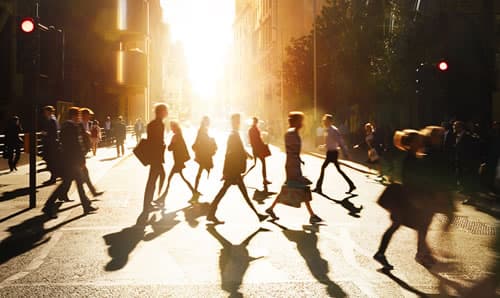 Business people walking through at city at dawn
