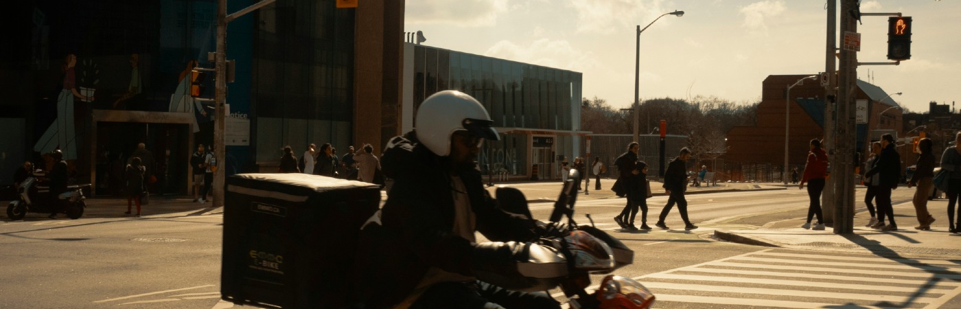 A man riding a motorbike in a city.
