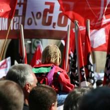 people marching with flags at employment rally