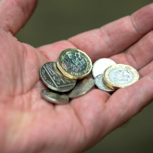 A selection of British coins in an open hand