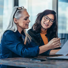 Two women chatting in the workplace