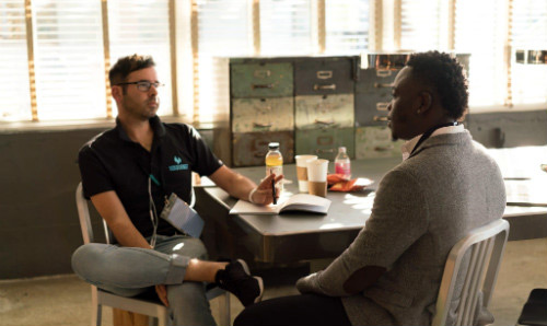 two men in workplace meeting