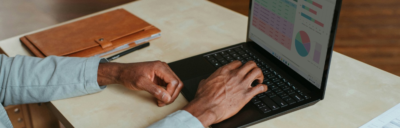 A man's working on a laptop.