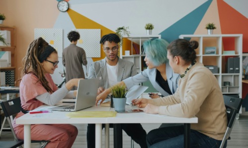 A group of people working around a table.